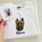 Fluffy Buddy custom embroidered pet portrait sweatshirt made from your photo, showing detailed stitching of a dog portrait on a cozy sweater
